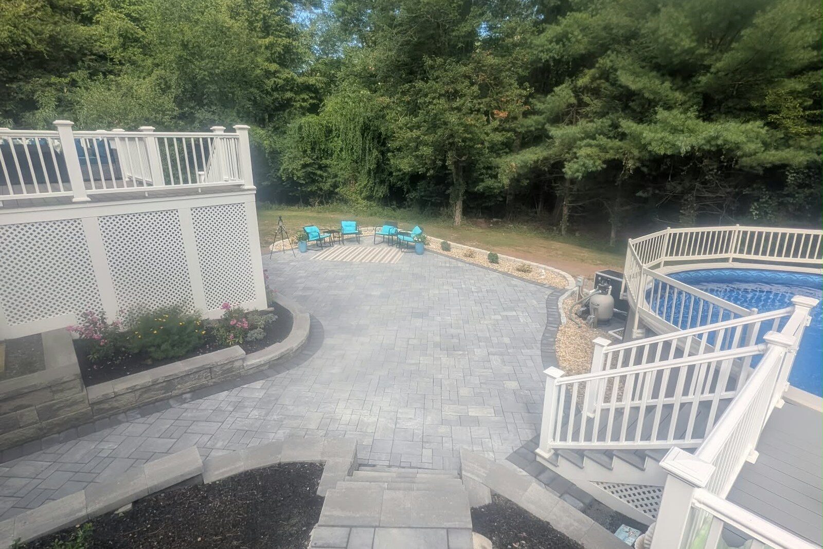 A curved stone patio tying a large yard together.