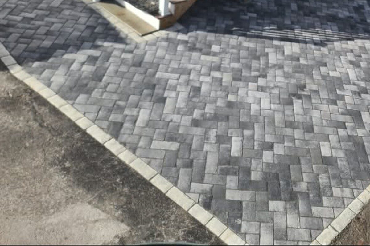 A patio set to the grade, with steps and a landing, on a site built for a cold winter.